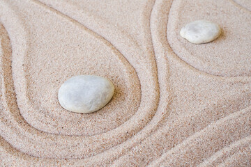 Fototapeta na wymiar Zen garden stone Japanese on raked sand. rock or pebbles on beach design outdoor for meditate peace of mind and relax. Buddhism religion concept.