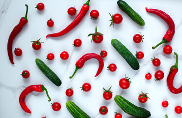 A frame of colorful vegetables on a marble background, a mock-up of the top view. Fresh healthy vegetables tomatoes,cucumbers, peppers