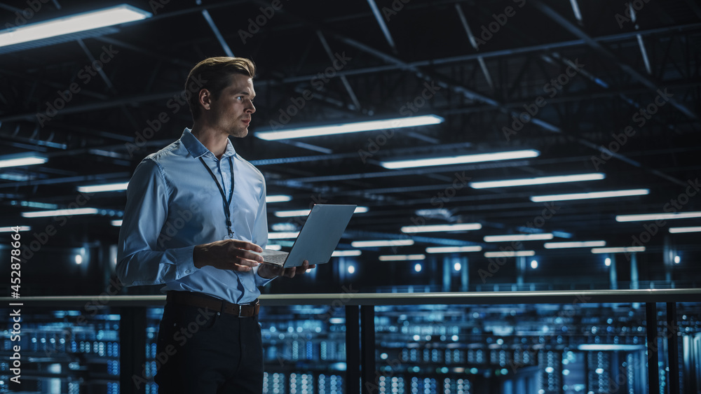 Poster Data Center Specialist Engineer Using Laptop Computer. Server Farm Cloud Computing Facility with Male System Administrator Working. Data Protection Network for Cyber Security.