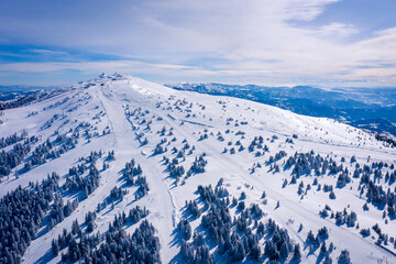 Panorama of the ski resort Kopaonik in Serbia. Kopaonik National Park, winter landscape in the mountains, coniferous forest covered with snow