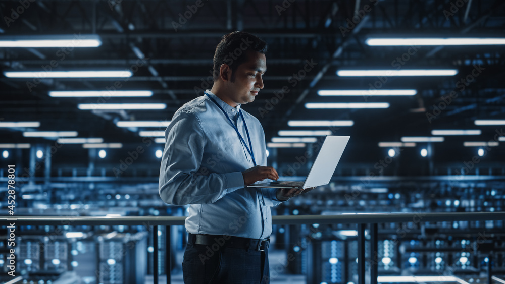 Aufkleber portrait of it specialist uses laptop in data center. server farm cloud computing facility with male