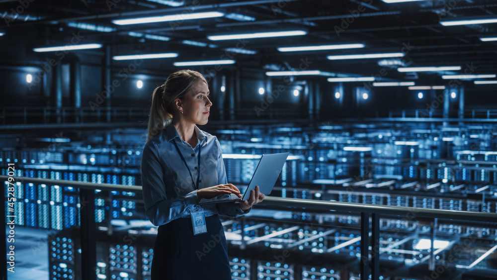 Leinwandbilder data center female it specialist using laptop. server farm cloud computing and cyber security mainte