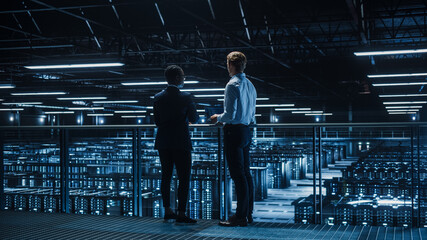 Data Center Male IT Specialist and Female e-Business Enrepreneur Talk, Use Laptop. Two Information...