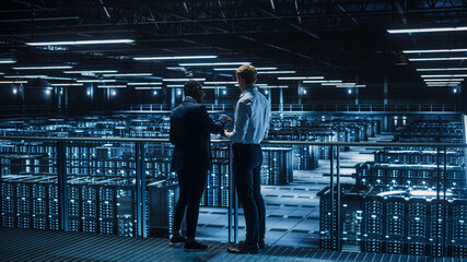 Data Center Male IT Specialist and Female e-Business Enrepreneur Talk, Use Laptop. Two Information...