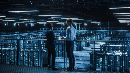 Data Center Male IT Specialist and Female e-Business Enrepreneur Talk, Use Laptop. Two Information...
