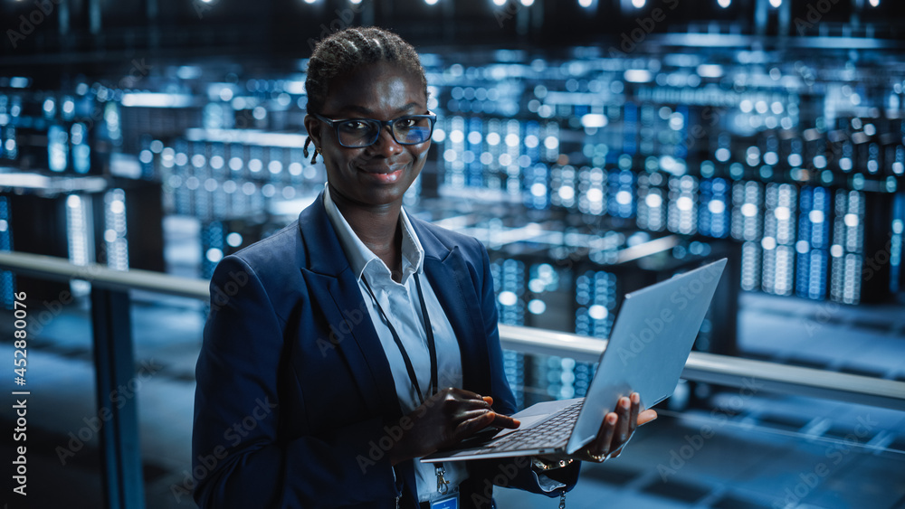 Poster Data Center: Female Programmer Using Laptop Computer, Smiling and Looking at Camera. In Cloud Computing Server Farm System Administrator Working on IT Maintenance for Iaas, saas, paas.