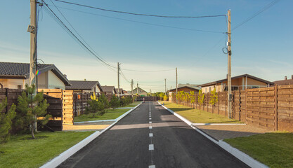 Cottage town. Street view with modern country houses and a beautiful road. High quality photo