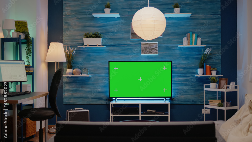 Poster green screen design on television in empty room at modern flat. chroma key digital concept on monito