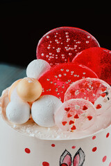 Festive children's cake with white glaze on a black background. Close-up. High quality photo