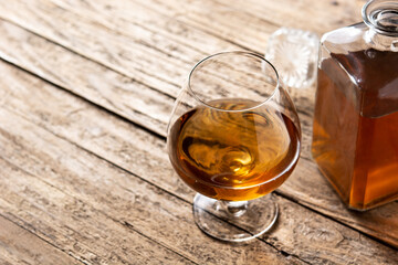 Cognac or whiskey drink on rustic wooden table. Copy space