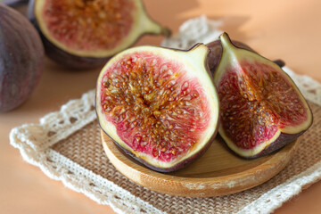 figs in a wooden plate on a woven napkin