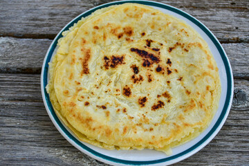 Bakery. Home made pancakes with   organic free range  eggs and white cheese on wooden background. Rustic style breakfast