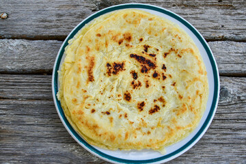 Bakery. Home made pancakes with   organic free range  eggs and white cheese on wooden background. Rustic style breakfast