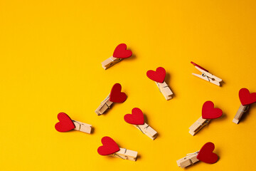heart shaped clothespins stationery decoration tools yellow background