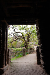 View from inside one of the passageways or tunnels made of slates and adobe that ends in a bridge
