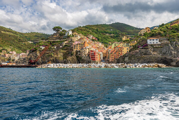 Fototapeta premium The famous Riomaggiore village seen from the Ligurian sea, tourist resort on the Cinque Terre coast, National Park in Liguria, La Spezia, Italy, Europe. UNESCO world heritage site. 