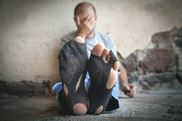 Poor feets of a caucasian homeless man.