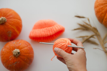 Crochetting a baby beanie hat and sweater halloween outfit from orange yarn