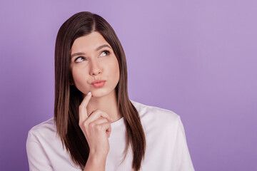 Photo of lady looking up empty space lips plump thinking arm on chin isolated on violet background