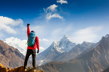 Hiker cheering elated and blissful with arms raised in the sky after hiking. Everest base camp trek - obrazy, fototapety, plakaty