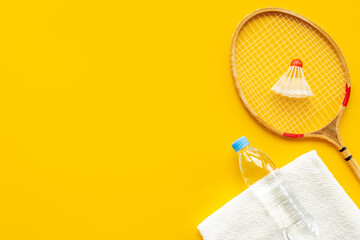 Competitive sports equipment. Two badminton rackets and shuttlecock with towel and water