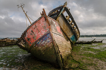 Old abandoned shipwrecks on the river bank