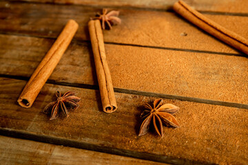 Cinnamon sticks on wooden background
