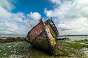 Old abandoned shipwrecks on the river bank