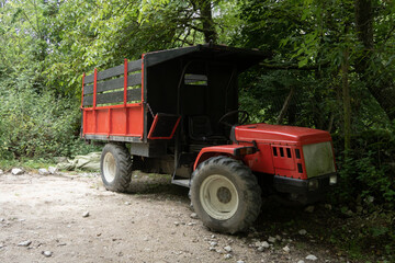 Fototapeta na wymiar red tractor in mountain village