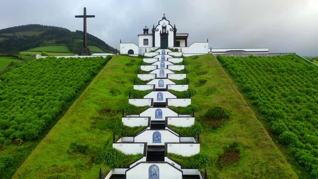 Aerial: Ermida De Nossa Senhora Da Paz Amidst Green Landscape Against Cloudy Sky - Azores, Portugal