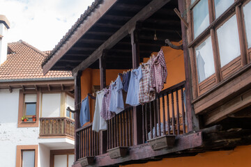 Obraz na płótnie Canvas clothes hanging on traditional balcony of northern Spain