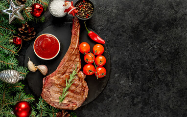 grilled Tomahawk steak with spices on a stone background with copy space for your text