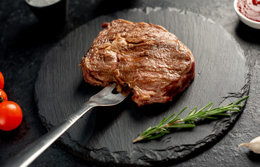 Ribeye grilled steak on stone background 