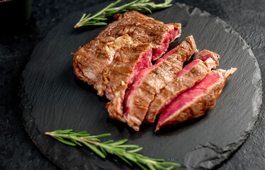 Ribeye grilled steak on stone background 