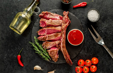grilled Tomahawk steak with spices on a stone background 