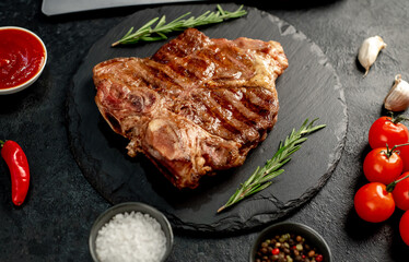 grilled T-bone steak on a stone background