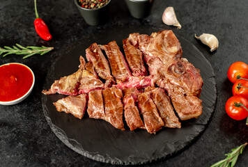 grilled T-bone steak on a stone background