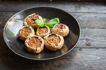 stuffed mushroom mushrooms stuffed baked no meat fresh portion ready to eat meal snack on the table copy space food background rustic. top view keto or paleo diet veggie vegan or vegetarian food