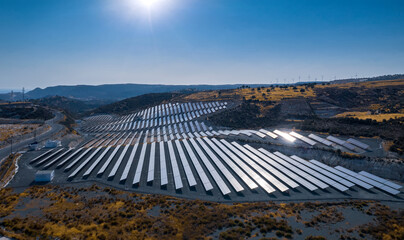 Photovoltaic panels of solar power station on a hill. Aerial landscape