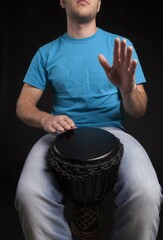 Man Playing the African Djembe Drum