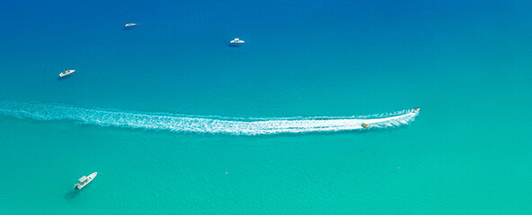 Speed boat with slider leave trail on water, sea panorama from above