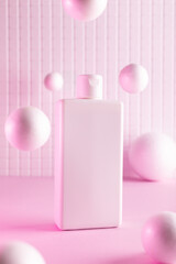 Cosmetic bottles with flying balls in a pink neon light, mock up