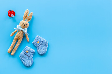 Knitted baby toy rabbit with newborn booties shoes, top view