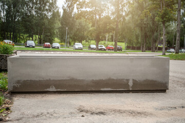 Empty concrete flower pot and barrier for cars