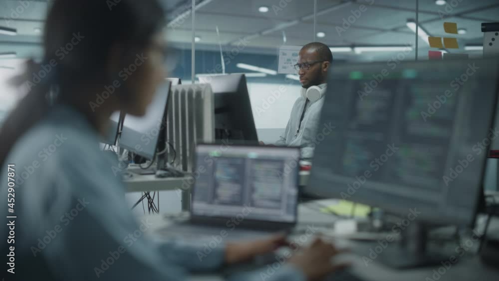 Poster Diverse Multi-Ethnic Team in Office: Indian Female and Black Male IT Programmers Working on Desktop Computer. Specialists Creating Software. Engineers Developing App, Program. Shifting Rack Focus