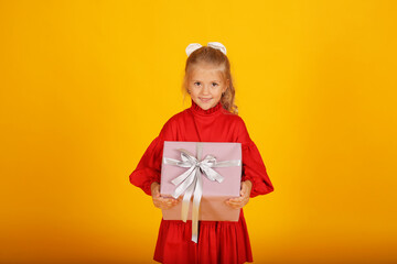 beautiful happy blonde girl in a red dress with a gift box in her hands holiday birthday