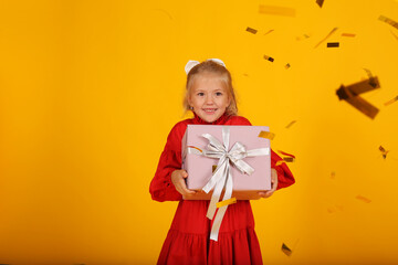 beautiful happy blonde girl in a red dress with a gift box in her hands holiday birthday