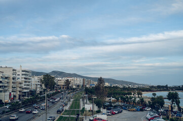 Cityscape of Athens, Greece. Top view from above of road and sea shore. Urban architecture. Mountains on background.