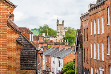 A view down narrow street towards the Cathedral in Winchester, UK in early summer