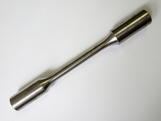 Steel specimen for traction tests isolated on background